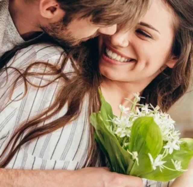 depositphotos_156649708-stock-photo-young-couple-embracing-with-bouquet